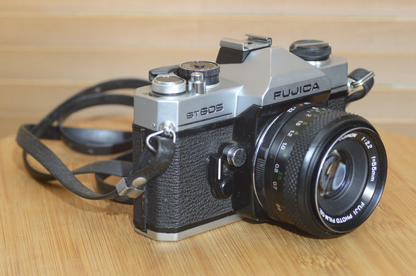Fujica ST605 35mm SLR camera with 55mm f2.2 lens and case, vintage Rewind Cameras model with a sturdy build and classic design.