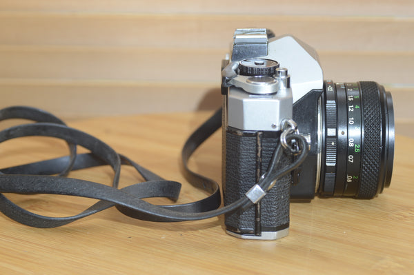 Vintage Fujica ST605 35mm SLR camera with 55mm f2.2 lens and case, showcasing a solid, striking retro camera design.