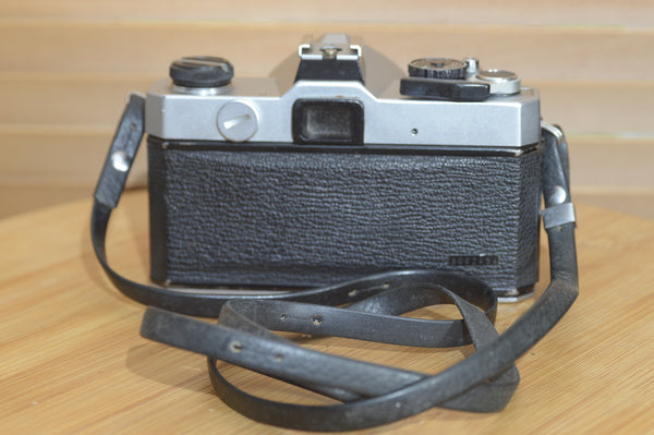 Fujica ST605 35mm SLR camera with 55mm f2.2 lens and case, vintage and solid metal construction, detailed view of camera body.