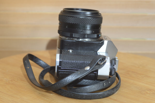 Vintage Fujica ST605 35mm SLR camera with 55mm f2.2 lens and case, showcasing its solid build and classic design.