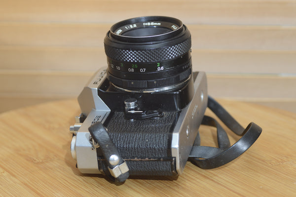 Fujica ST605 35mm SLR camera with 55mm f2.2 lens and case, vintage solid metal construction, classic photography equipment.