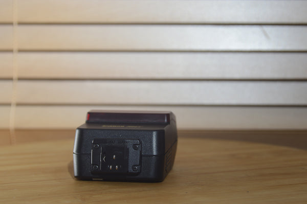 Canon Speedlite 244T flash unit with case and original box, vintage camera accessory for professional photography.