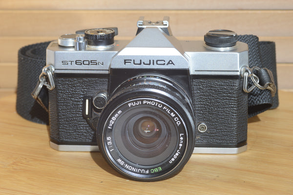 Fujica ST605n SLR with 28mm f3.5 lens and case.  A striking vintage camera.