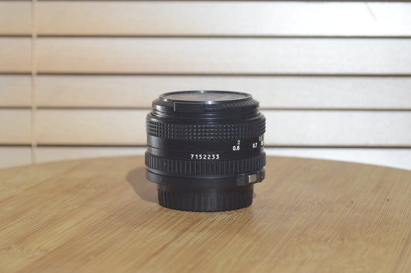 Canon FDn 50mm f1.8 prime lens in excellent condition, Olympic Games Edition, 35mm film camera lens with clean glass and metal body.