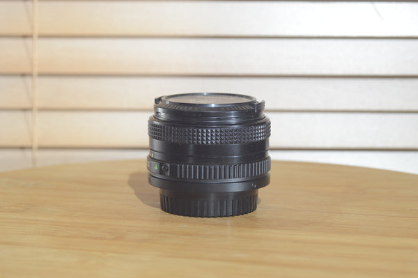 Canon FDn 50mm f1.8 prime lens, 35mm, Olympic Games Edition, in fantastic condition with visible lens elements and mount.
