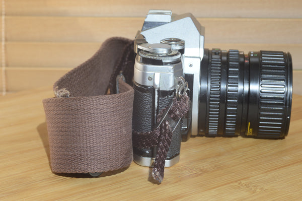 Canon AE1 with Canon FD 35-70mm  lens and strap. Fantastic set up for all levels.