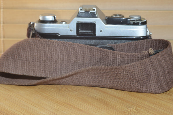 Canon AE1 with Canon FD 35-70mm  lens and strap. Fantastic set up for all levels.