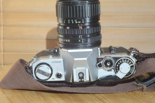 Canon AE1 with Canon FD 35-70mm  lens and strap. Fantastic set up for all levels.