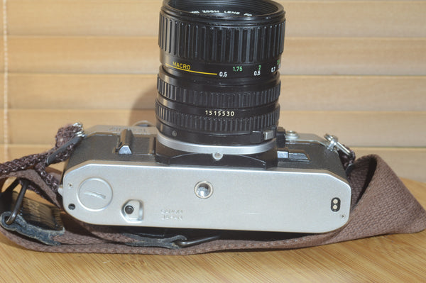 Canon AE1 with Canon FD 35-70mm  lens and strap. Fantastic set up for all levels.
