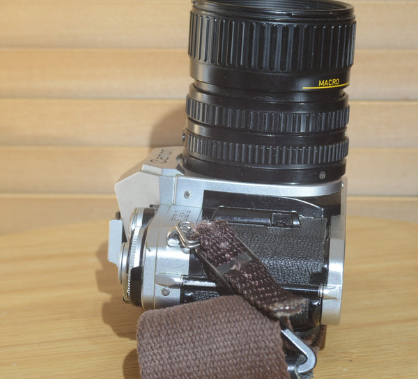 Canon AE1 with Canon FD 35-70mm  lens and strap. Fantastic set up for all levels.