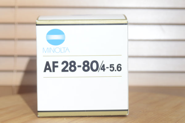 Minolta AF 28-80mm f/3.5-5.6 camera lens with auto focus, shown with box, compatible with Minolta 35mm and digital cameras.