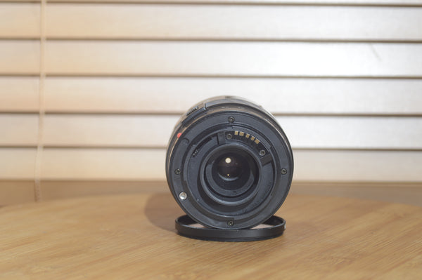 Minolta AF 28-80mm f/3.5-5.6 camera lens with auto focus, shown with its box, compatible with Minolta 35mm and digital cameras.