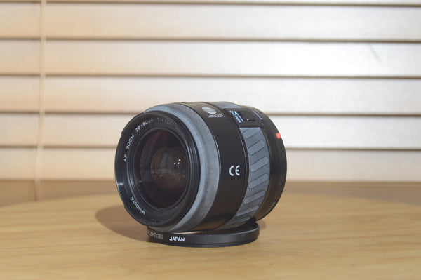 Minolta AF 28-80mm f/3.5-5.6 camera lens with autofocus, shown in box for Minolta 35mm or digital cameras, RewindCameras.