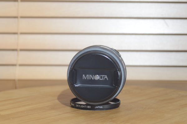 Minolta AF 28-80mm f/3.5-5.6 camera lens with autofocus, shown with box, compatible with Minolta 35mm and digital cameras