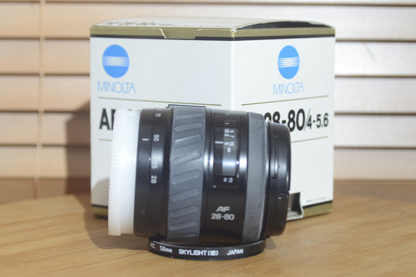 Minolta AF 28-80mm f/3.5-5.6 camera lens with autofocus, boxed, suitable for Minolta 35mm and digital cameras.