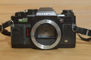 Black Olympus OM40 programme 35mm SLR (body only). Great condition. - Rewind Cameras 