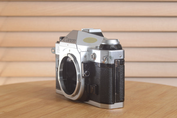 Canon AE1 P 35mm SLR camera body by Rewind Cameras displayed with focus on the camera's front and controls.