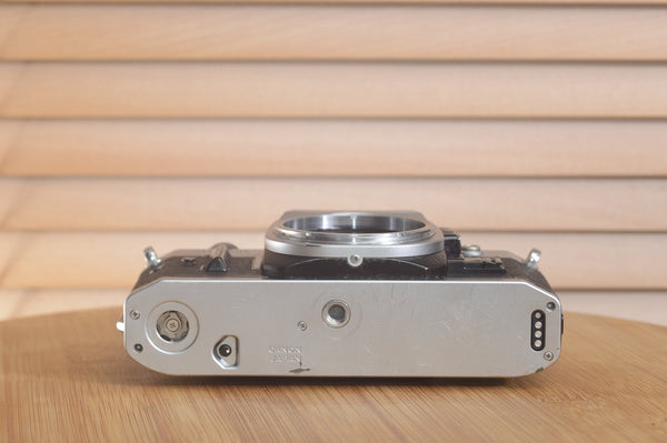 Canon AE1 P 35mm SLR camera body by Rewind Cameras, shown with standard controls and vintage design.