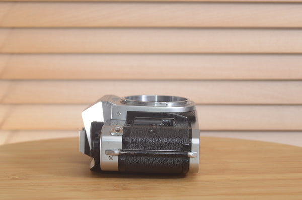 Canon AE1 P 35mm SLR camera body by Rewind Cameras, showing the vintage black camera with dials and lens mount.