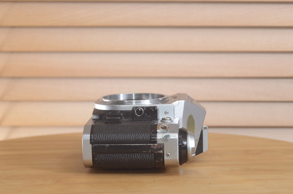 Canon AE1 P 35mm SLR camera body by Rewind Cameras, showing the front view with dials and grip details.