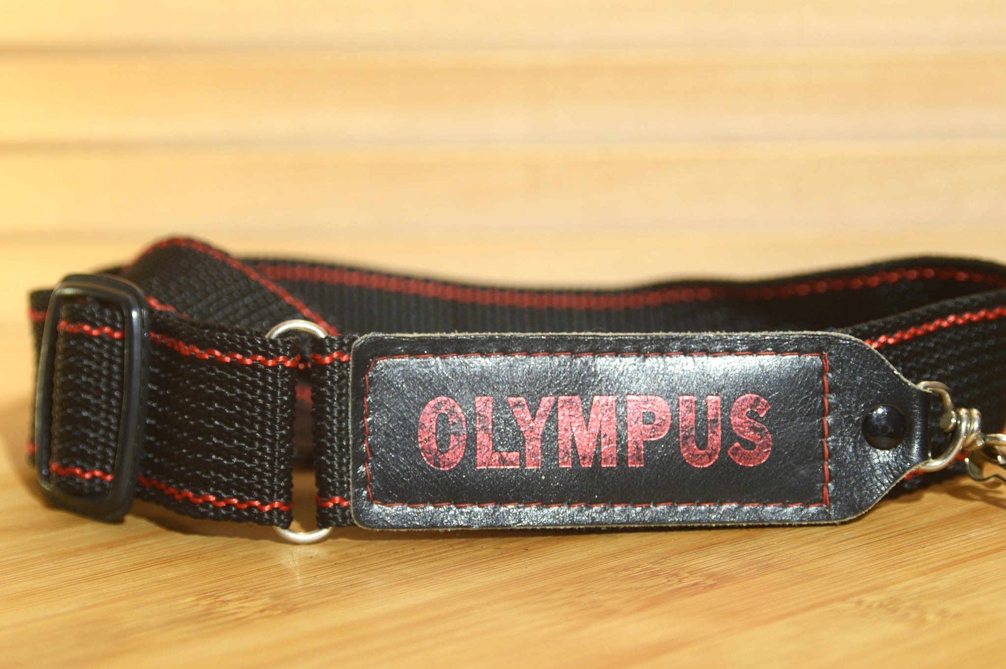 Black and Red Olympus strap. Lovely addition to your Olympus set up.