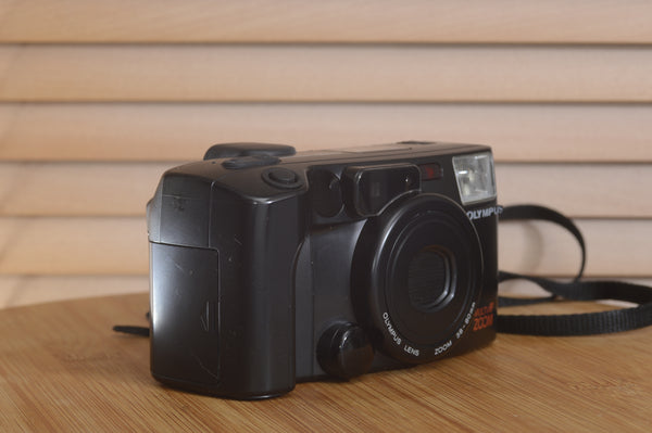 Pentax AZ200 35mm film camera in its original box, in excellent condition, with a sleek black body and compact design.