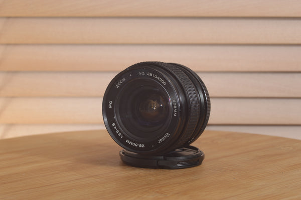 Vivitar Zoom PK 28-50mm f3.5-4.5 Pentax camera lens with metal mount and zoom ring, photographed on a white background.