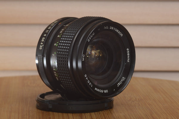 Vivitar Zoom PK (Pentax) 28-50mm f3.5-4.5 camera lens with focus and zoom rings, metal body, and aperture control.