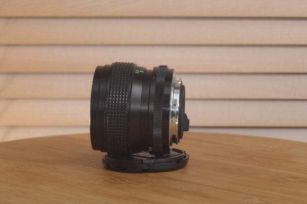 Vivitar Zoom PK (Pentax) 28-50mm f3.5-4.5 lens on a camera, showing the lens barrel with focus and zoom rings.