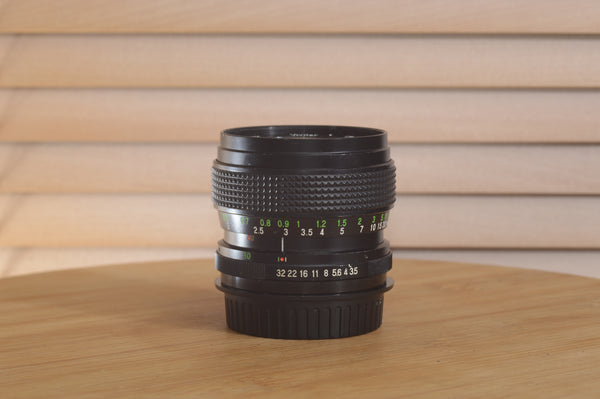 Vivitar Zoom PK (Pentax) 28-50mm f/3.5-4.5 camera lens with focus and zoom rings, shown on a neutral background