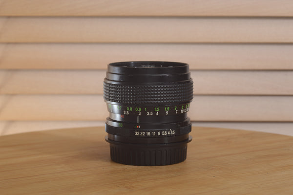 Vivitar Zoom PK Pentax 28-50mm f/3.5-4.5 camera lens with focus and zoom rings, metal construction, and aperture control.