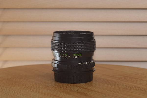 Vivitar Zoom PK Pentax 28-50mm f/3.5-4.5 camera lens showing front and side view with focus and zoom rings.