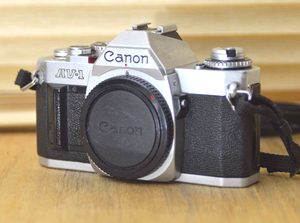 Canon AV1 SLR camera (body only) with very useful strap. These are perfect for beginners or those who want to explore vintage photography.