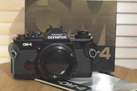 Boxed Black Olympus OM4 SLR Camera Body. In Fantastic condition. Comes with original packaging and Manuals - RewindCameras quality vintage cameras, fully tested and serviced