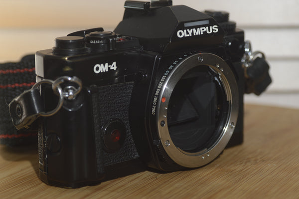 Black Olympus OM4 SLR Camera Body With Olympus Strap. In Fantastic condition. - RewindCameras quality vintage cameras, fully tested and serviced