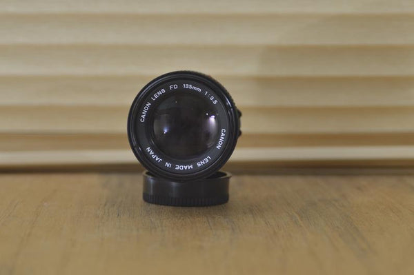 Canon FD 135mm 3.5 lens with built in lens hood in box. Beautiful lens especially for portraiture work. Stunning optics with Fab results! - RewindCameras quality vintage cameras, fully tested