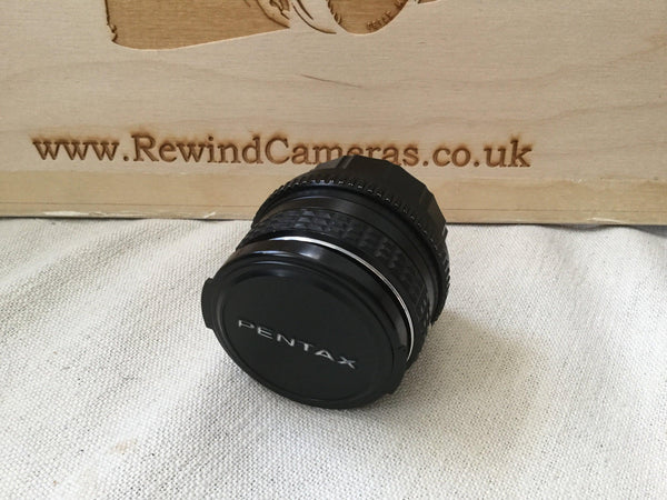 Pentax M 28mm 3.5 Lens wide angle lens, the focus works correctly and the aperture is good and snappy. Great sharp bright prime lens - RewindCameras quality vintage cameras, fully tested and 