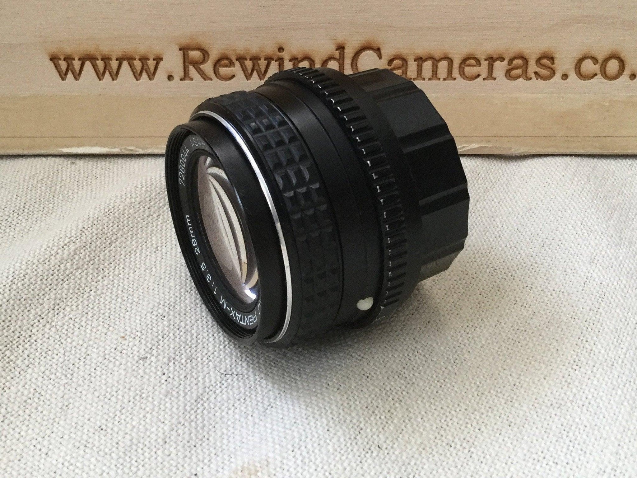 Pentax M 28mm 3.5 Lens wide angle lens, the focus works correctly and the aperture is good and snappy. Great sharp bright prime lens - RewindCameras quality vintage cameras, fully tested and 
