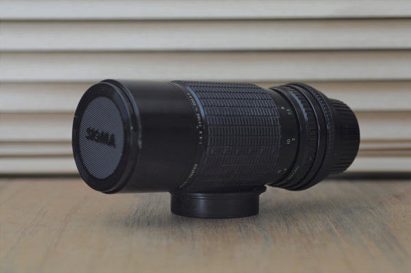 Sigma M42 100-200mm f4.5 Zoom lens with built in lens hood and dedicated case. - RewindCameras quality vintage cameras, fully tested and serviced