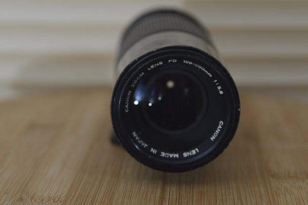 Lovely Canon FD 100-200mm f5.6 Zoom lens with case - RewindCameras quality vintage cameras, fully tested and serviced